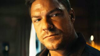 Batman di alan ritchson: un  costume dettagliato con cintura gialla e cappuccio minaccioso